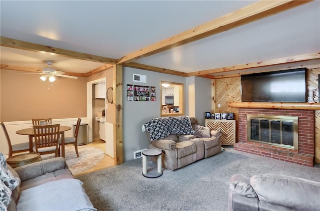 304 Petain St, Ellwood City Law, PA 16117 - living room featuring beam ceiling, ceiling fan, a fireplace, carpet floors, and wooden walls