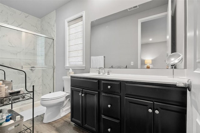 303 Tillary Ln Unit 201, Cranberry Twp, PA 16066 - bathroom featuring vanity, a marble finish shower, toilet, and wood finished floors