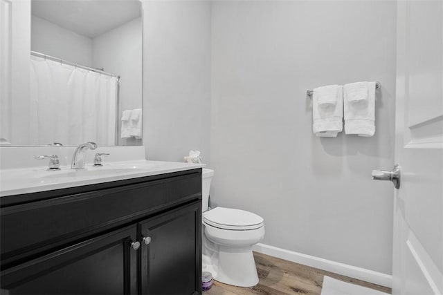 303 Tillary Ln Unit 201, Cranberry Twp, PA 16066 - bathroom with vanity, wood finished floors, toilet, and baseboards