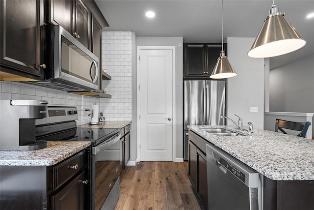 303 Tillary Ln Unit 201, Cranberry Twp, PA 16066 - kitchen featuring appliances with stainless steel finishes, a sink, dark wood-type flooring, a kitchen island with sink, and light stone counters