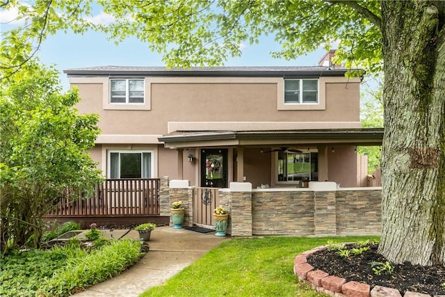 887 E Arcadia Dr, Mccandless, PA 15237 - traditional-style house with stucco siding, a fenced front yard, stone siding, a gate, and a chimney