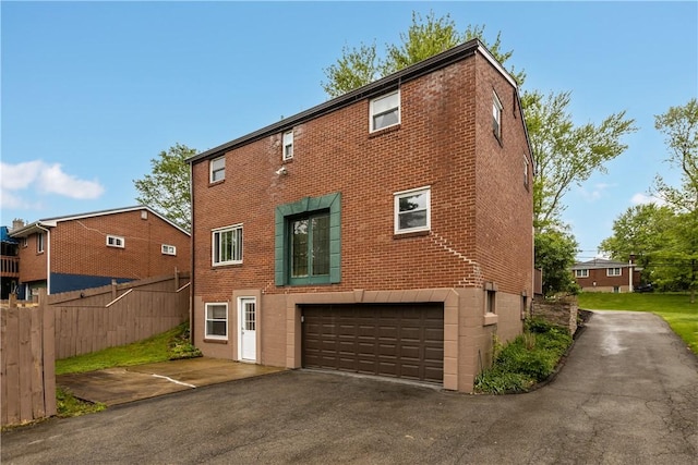 887 E Arcadia Dr, Mccandless, PA 15237 - rear view of house with a garage, driveway, and brick siding