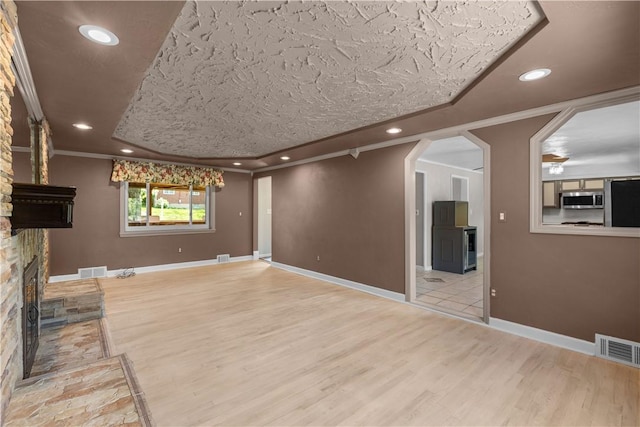 887 E Arcadia Dr, Mccandless, PA 15237 - unfurnished living room featuring wood finished floors, a large fireplace, crown molding, recessed lighting, and arched walkways