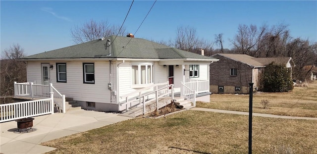 32 John Dr, Hanover Twp Wsh, PA 15021 - back of house with a fire pit, a yard, a chimney, and a shingled roof
