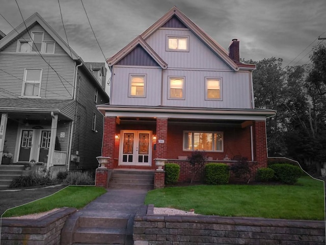 204 Biddle Ave, Regent Square, PA 15221 - view of front of home with brick siding, french doors, covered porch, and a chimney