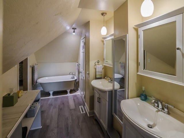 204 Biddle Ave, Regent Square, PA 15221 - full bath with lofted ceiling, a soaking tub, wood finished floors, and two vanities