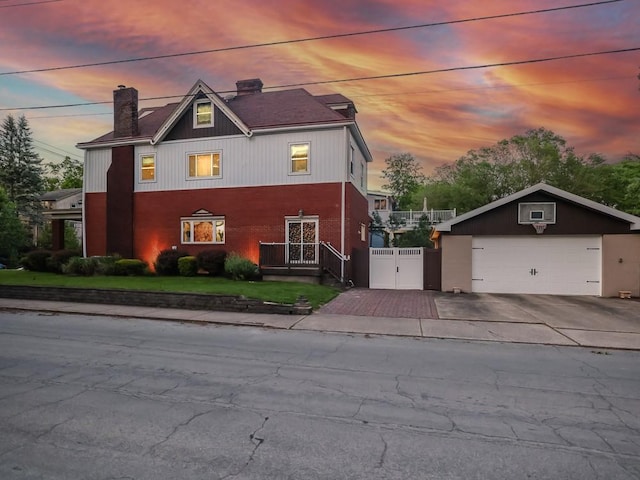 204 Biddle Ave, Regent Square, PA 15221 - view of front of home featuring a chimney, a gate, a detached garage, and brick siding