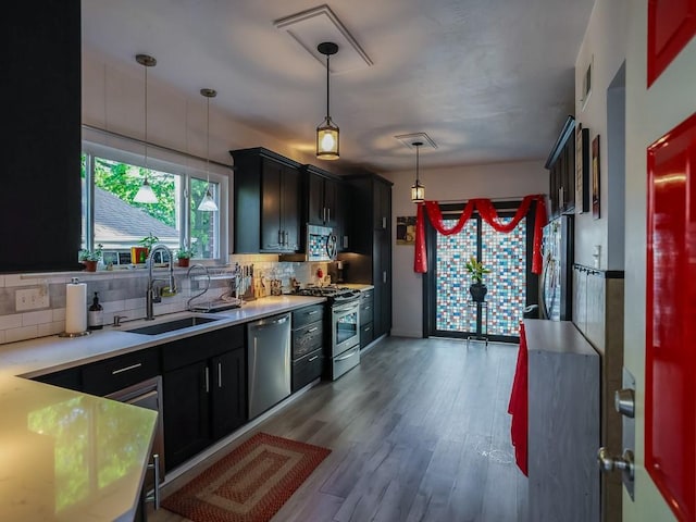 204 Biddle Ave, Regent Square, PA 15221 - kitchen featuring a sink, stainless steel appliances, decorative backsplash, and light countertops