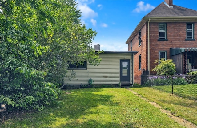 2914 5th Ave, Beaver Falls, PA 15010 - rear view of property with a chimney and brick siding