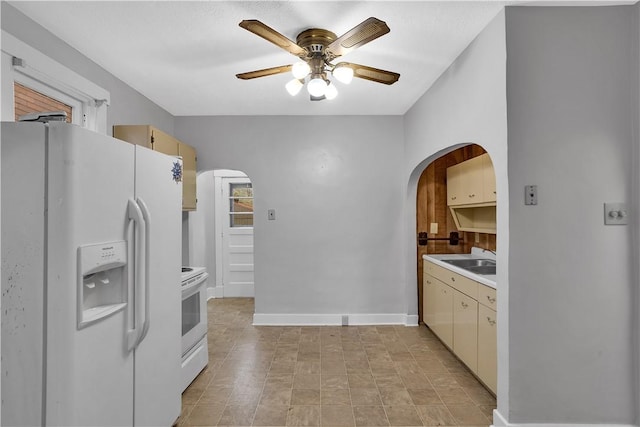 2914 5th Ave, Beaver Falls, PA 15010 - kitchen with white appliances, a ceiling fan, arched walkways, light countertops, and baseboards