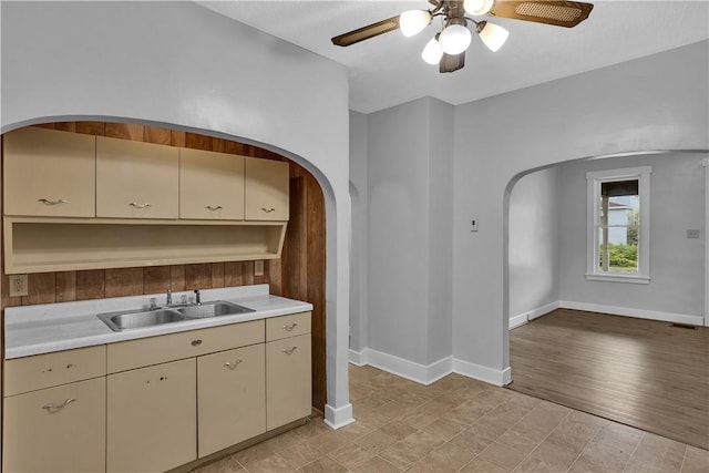 2914 5th Ave, Beaver Falls, PA 15010 - kitchen featuring a sink, arched walkways, and cream cabinets