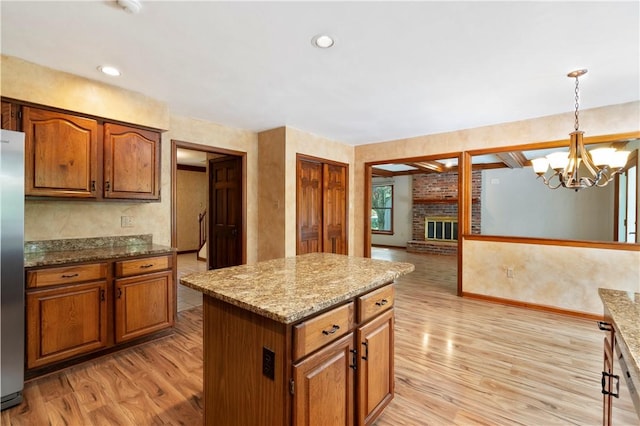 2662 Timberglen Dr W, Franklin Park, PA 15090 - kitchen featuring light wood-style floors, a brick fireplace, and brown cabinetry