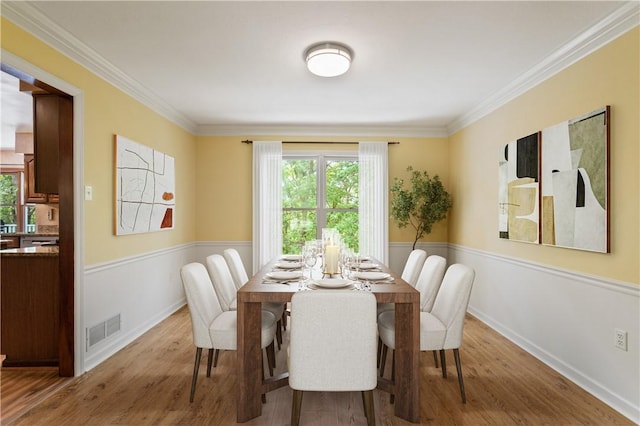 2662 Timberglen Dr W, Franklin Park, PA 15090 - dining area with a wainscoted wall, wood finished floors, and crown molding