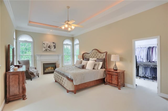 606 Adare Ct, Cranberry Twp, PA 16066 - bedroom with carpet, a tray ceiling, baseboards, a warm lit fireplace, and crown molding