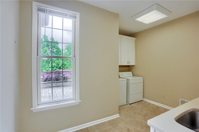 606 Adare Ct, Cranberry Twp, PA 16066 - laundry room featuring cabinet space, washer and dryer, plenty of natural light, and baseboards