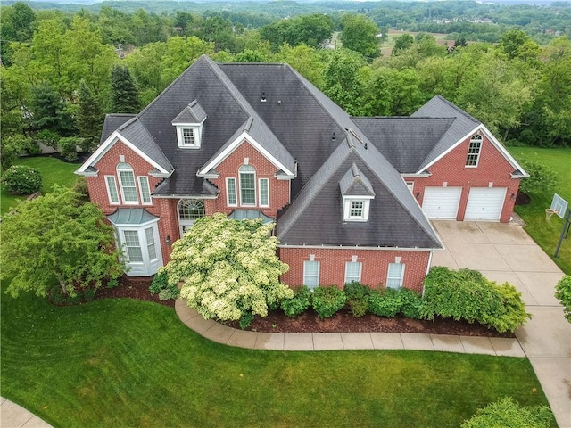 606 Adare Ct, Cranberry Twp, PA 16066 - view of front of home featuring brick siding, a garage, concrete driveway, and a front lawn