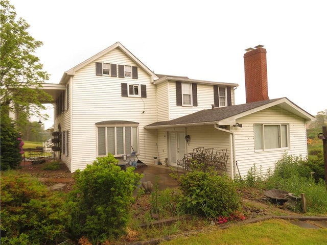 629 Freeport Rd, Jefferson Twp But, PA 16002 - rear view of property featuring a patio area and a chimney