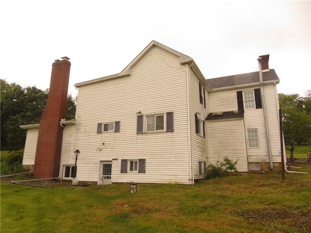 629 Freeport Rd, Jefferson Twp But, PA 16002 - rear view of property with a chimney and a lawn