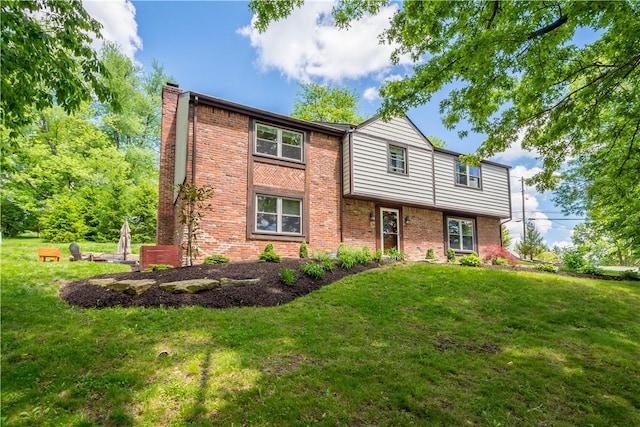 2507 Corteland Dr, Upper St Clair, PA 15241 - view of front facade with a front yard, a chimney, and brick siding