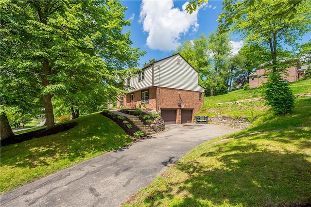 2507 Corteland Dr, Upper St Clair, PA 15241 - view of property exterior with brick siding, a garage, asphalt driveway, and a lawn