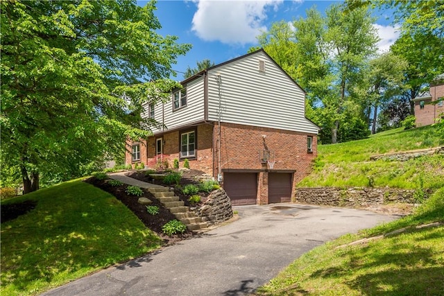2507 Corteland Dr, Upper St Clair, PA 15241 - view of side of home featuring brick siding, an attached garage, asphalt driveway, and a yard