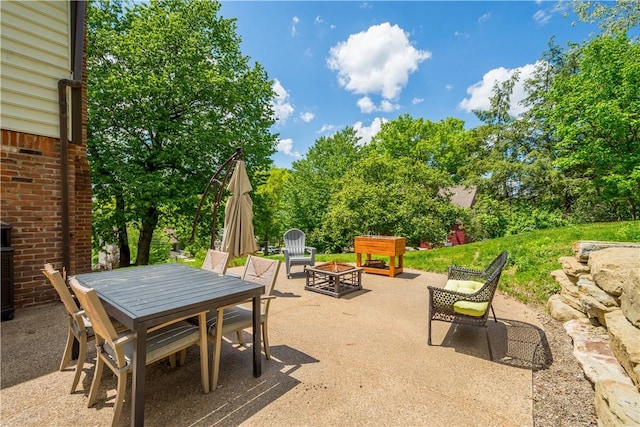 2507 Corteland Dr, Upper St Clair, PA 15241 - view of patio with a fire pit, outdoor dining area, and view of scattered trees