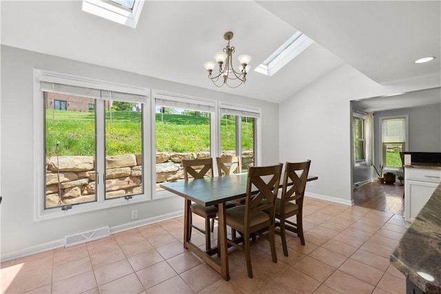 2507 Corteland Dr, Upper St Clair, PA 15241 - dining area featuring a skylight, lofted ceiling, light tile patterned floors, a chandelier, and baseboards