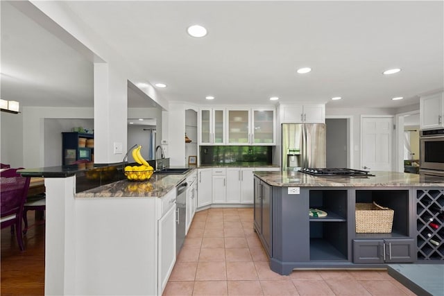 2507 Corteland Dr, Upper St Clair, PA 15241 - kitchen with open shelves, appliances with stainless steel finishes, a sink, dark stone counters, and glass insert cabinets