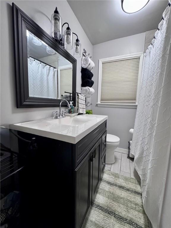 608 Wible Run Rd, Shaler, PA 15209 - full bathroom with toilet, vanity, and baseboards