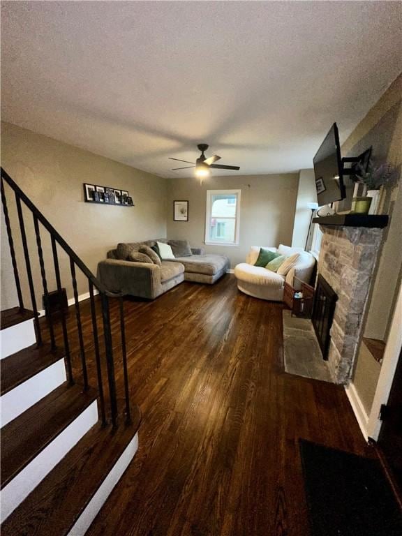 608 Wible Run Rd, Shaler, PA 15209 - living room featuring dark wood-style flooring, ceiling fan, a textured ceiling, a fireplace, and stairway