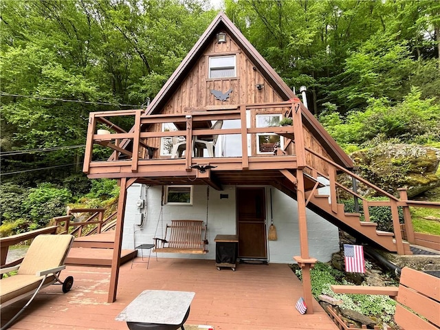 688 N Tunnel Rd, Pa, PA 16374 - rear view of property with a deck, stairway, and a view of trees