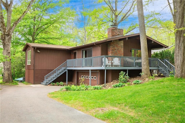 906 Aztec Trl, Coolspring Twp, PA 16137 - view of front facade featuring stairway, a chimney, driveway, and a front lawn