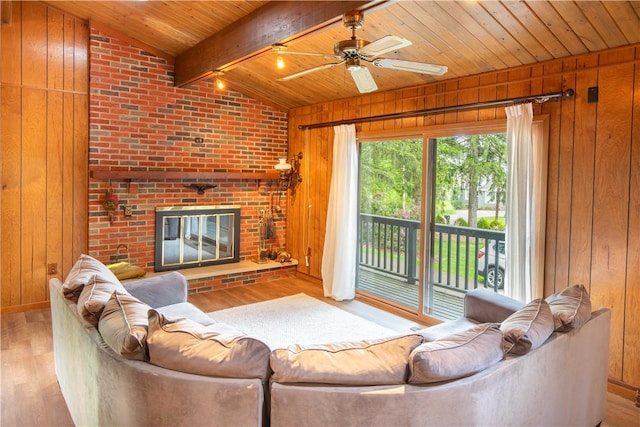 906 Aztec Trl, Coolspring Twp, PA 16137 - living area with wooden ceiling, wooden walls, wood finished floors, a fireplace, and ceiling fan