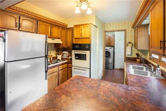 906 Aztec Trl, Coolspring Twp, PA 16137 - kitchen featuring white appliances, wallpapered walls, a sink, under cabinet range hood, and brick patterned flooring