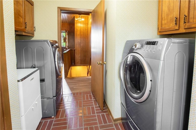 906 Aztec Trl, Coolspring Twp, PA 16137 - washroom featuring washer and clothes dryer, brick patterned floors, wallpapered walls, cabinet space, and baseboards