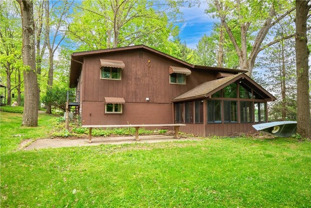 906 Aztec Trl, Coolspring Twp, PA 16137 - back of house with a sunroom and a lawn