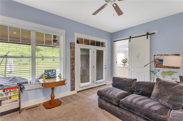 5525 Fontana Ct, Murrysville, PA 15632 - living area featuring carpet floors, a barn door, a ceiling fan, and baseboards