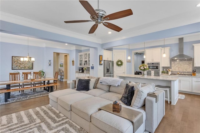 5525 Fontana Ct, Murrysville, PA 15632 - living room with wood finished floors, recessed lighting, a ceiling fan, a chandelier, and crown molding