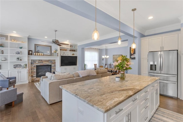 5525 Fontana Ct, Murrysville, PA 15632 - kitchen featuring stainless steel fridge with ice dispenser, ornamental molding, open floor plan, wood finished floors, and light stone counters