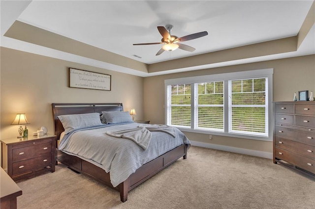 5525 Fontana Ct, Murrysville, PA 15632 - bedroom featuring light carpet, a tray ceiling, baseboards, and a ceiling fan