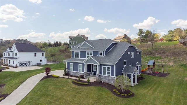 5525 Fontana Ct, Murrysville, PA 15632 - view of front facade with stone siding, a front lawn, a porch, a playground, and roof with shingles