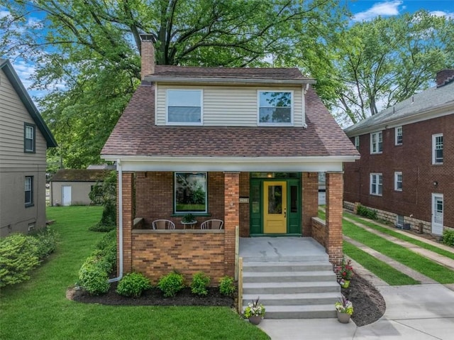 212 Orchard Pl, Sewickley, PA 15143 - view of front facade with a porch, a chimney, brick siding, a front lawn, and a shingled roof