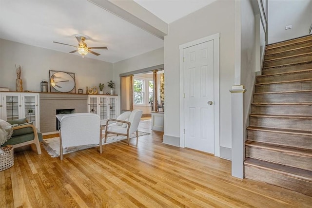 212 Orchard Pl, Sewickley, PA 15143 - living room featuring ceiling fan, light wood-type flooring, stairs, and a fireplace