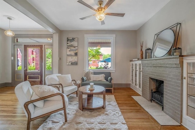 212 Orchard Pl, Sewickley, PA 15143 - living area with ceiling fan, a brick fireplace, baseboards, and wood finished floors