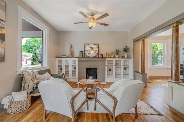 212 Orchard Pl, Sewickley, PA 15143 - living room featuring plenty of natural light, a fireplace, a ceiling fan, and ornate columns