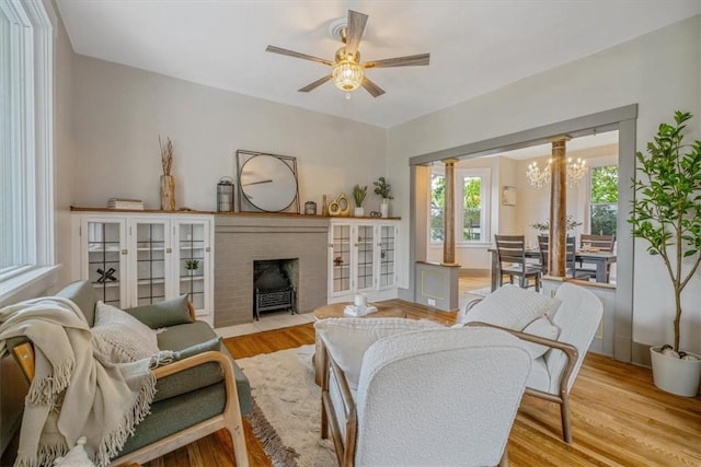 212 Orchard Pl, Sewickley, PA 15143 - living area featuring a ceiling fan, wood finished floors, a fireplace, and a chandelier