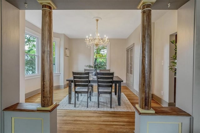 212 Orchard Pl, Sewickley, PA 15143 - dining room featuring decorative columns, plenty of natural light, and light wood-style flooring