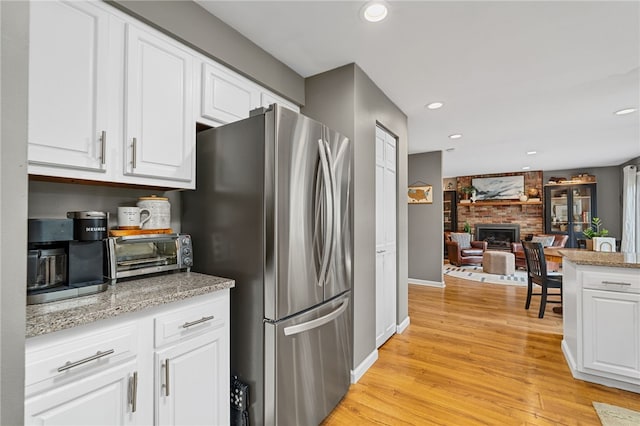 161 Ridgeview Dr, Mccandless, PA 15090 - kitchen with freestanding refrigerator, white cabinets, light wood-style floors, recessed lighting, and baseboards
