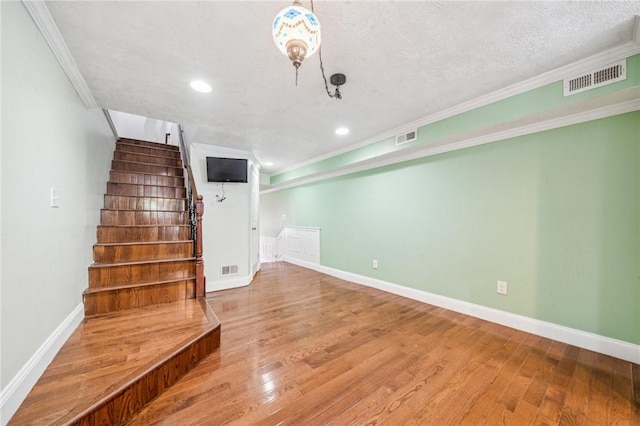 324 Orwell Way, Bloomfield, PA 15224 - stairs with ornamental molding, wood finished floors, recessed lighting, and baseboards