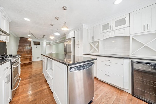 324 Orwell Way, Bloomfield, PA 15224 - kitchen with wine cooler, stainless steel appliances, dark countertops, white cabinets, and a kitchen island